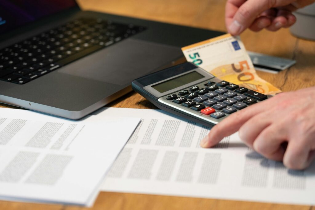 Man Hands over Documents and Calculator