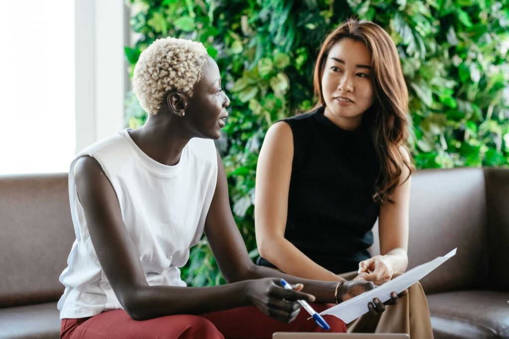 Multiethnic colleagues discussing criteria on paper