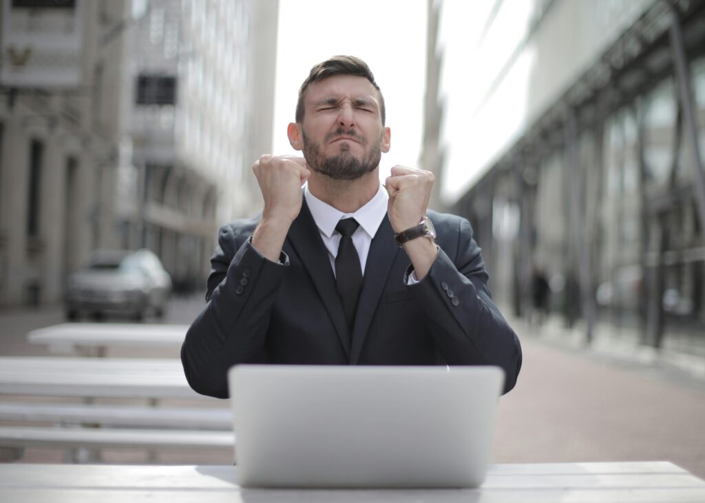 man in black suit celebrating his investments