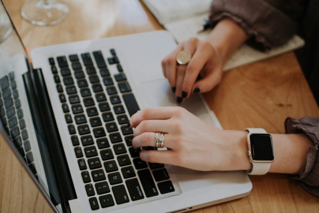 person using macbook to invest in peer-to-peer lending